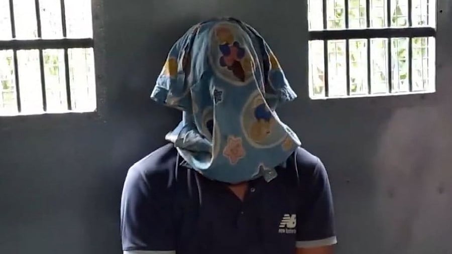 <div class="paragraphs"><p>Screengrab of video showing accused Sanjoy Roy in a police van with his face covered.</p></div>
